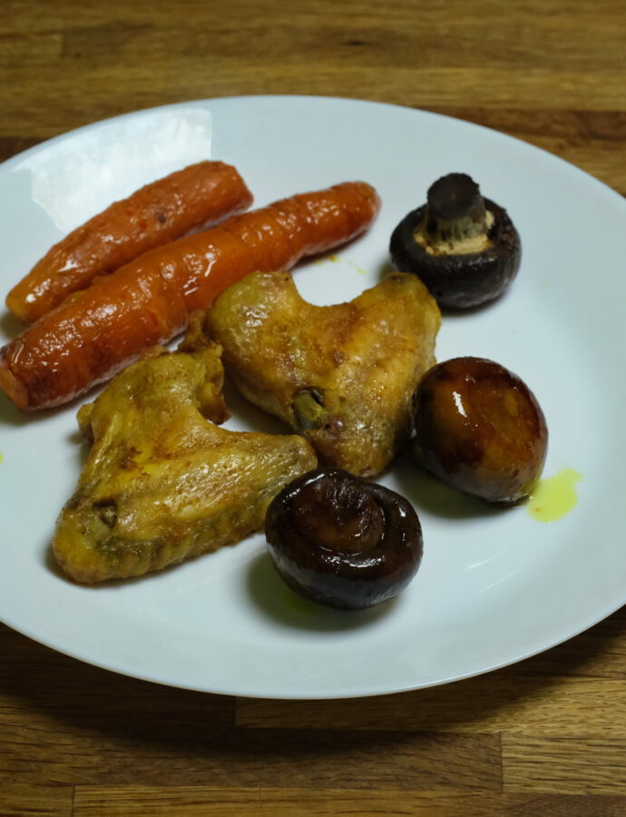 Hühnerflügel mit Karotten und Pilzen